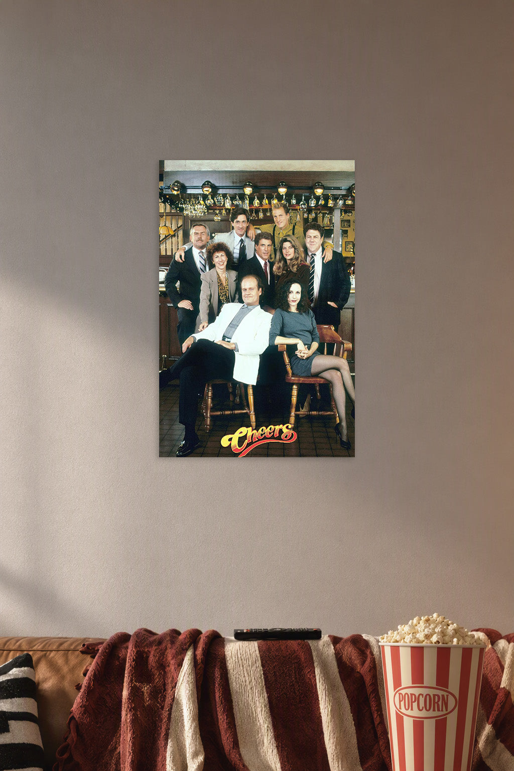 Cheers TV Show Cast in a cozy movie room above a brown sofa with popcorn.