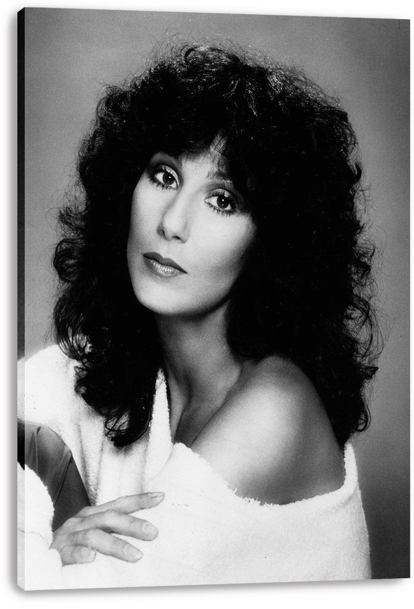 Cher canvas wall art print presents a monochrome close-up portrait of the singer with curly dark hair and a white textured wrap.