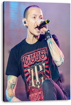 Chester Bennington canvas wall art print features the tattooed singer holding a microphone onstage, presented with visible wrapped canvas edges.