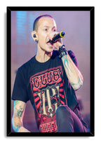 Chester Bennington framed wall art print portrays the singer mid-performance with a microphone, colorful tattoos, and a black frame.
