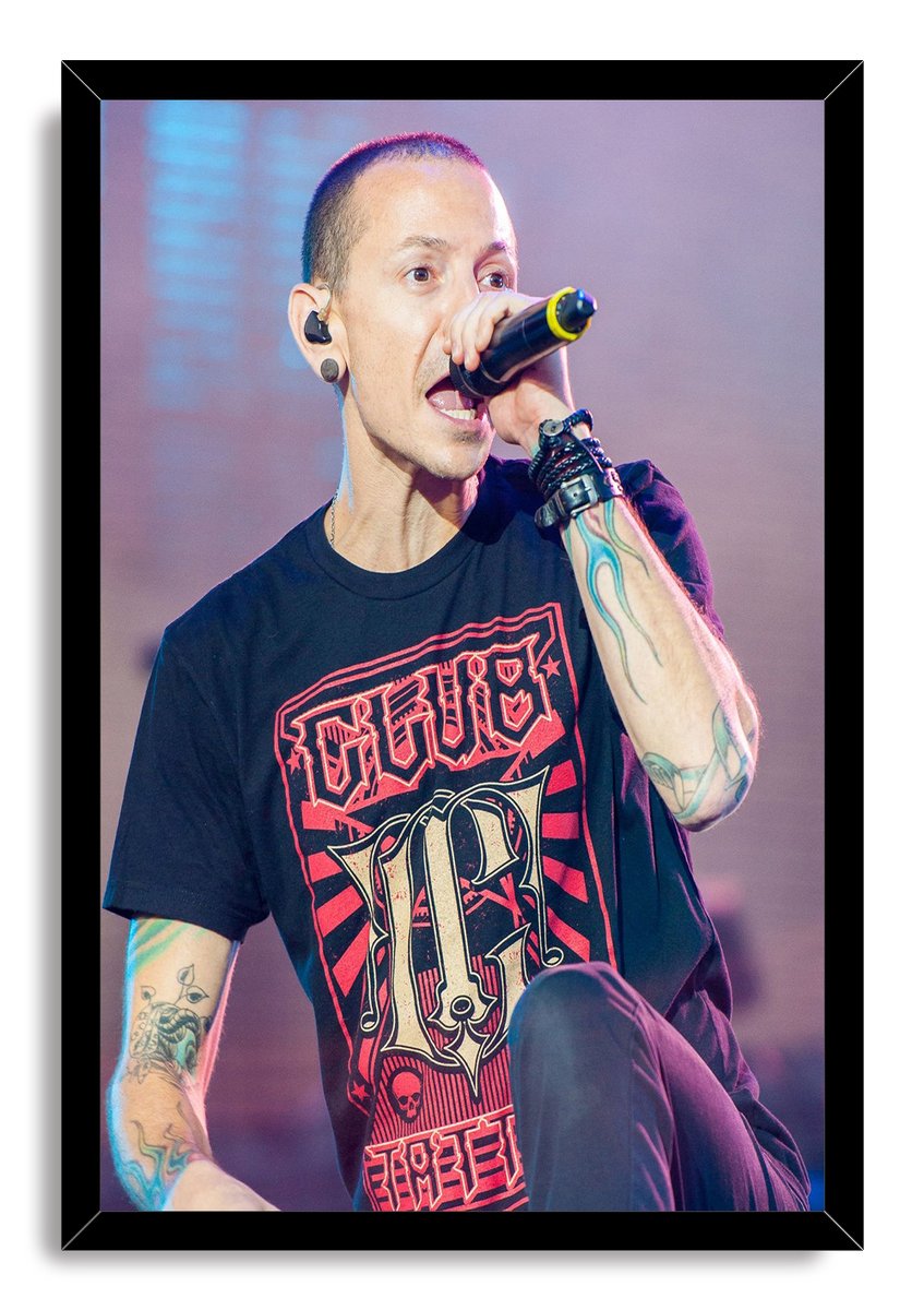 Chester Bennington framed wall art print portrays the singer mid-performance with a microphone, colorful tattoos, and a black frame.