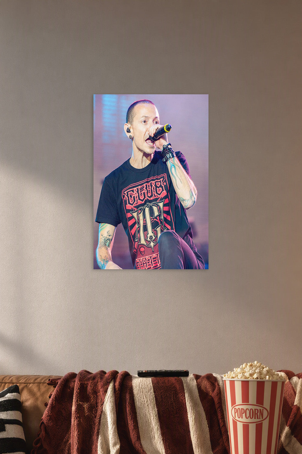 Chester Bennington in a cozy movie room above a brown sofa with popcorn.