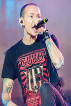 Chester Bennington poster captures the singer performing into a handheld microphone in a black graphic T-shirt under purple stage lights.