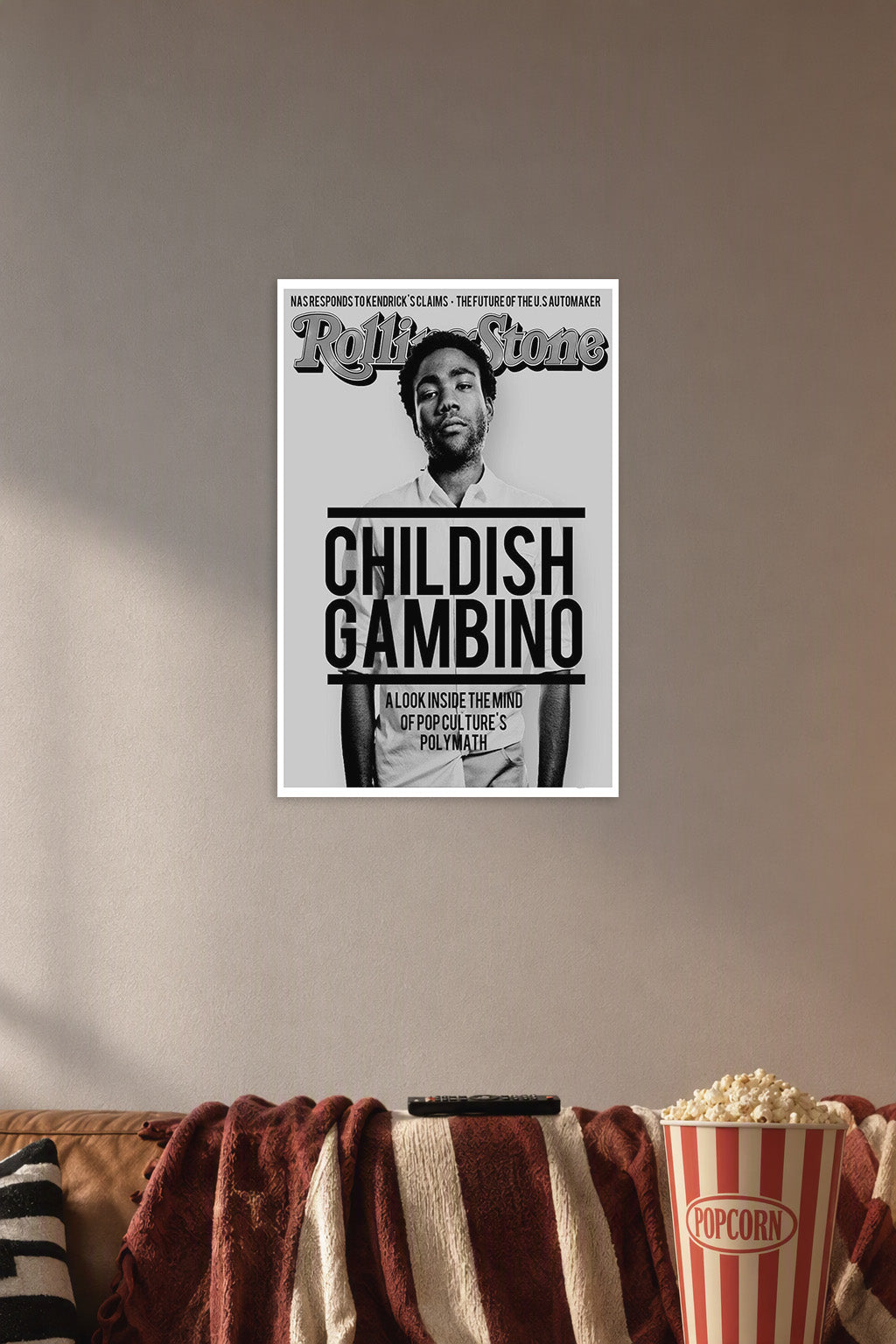 Childish Gambino in a cozy movie room above a brown sofa with popcorn.