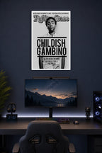 Childish Gambino in a gaming desk setup above a monitor.