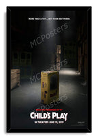 Child's Play framed wall art print presents the yellow Buddi toy box in a dim warehouse, bordered by a black frame.