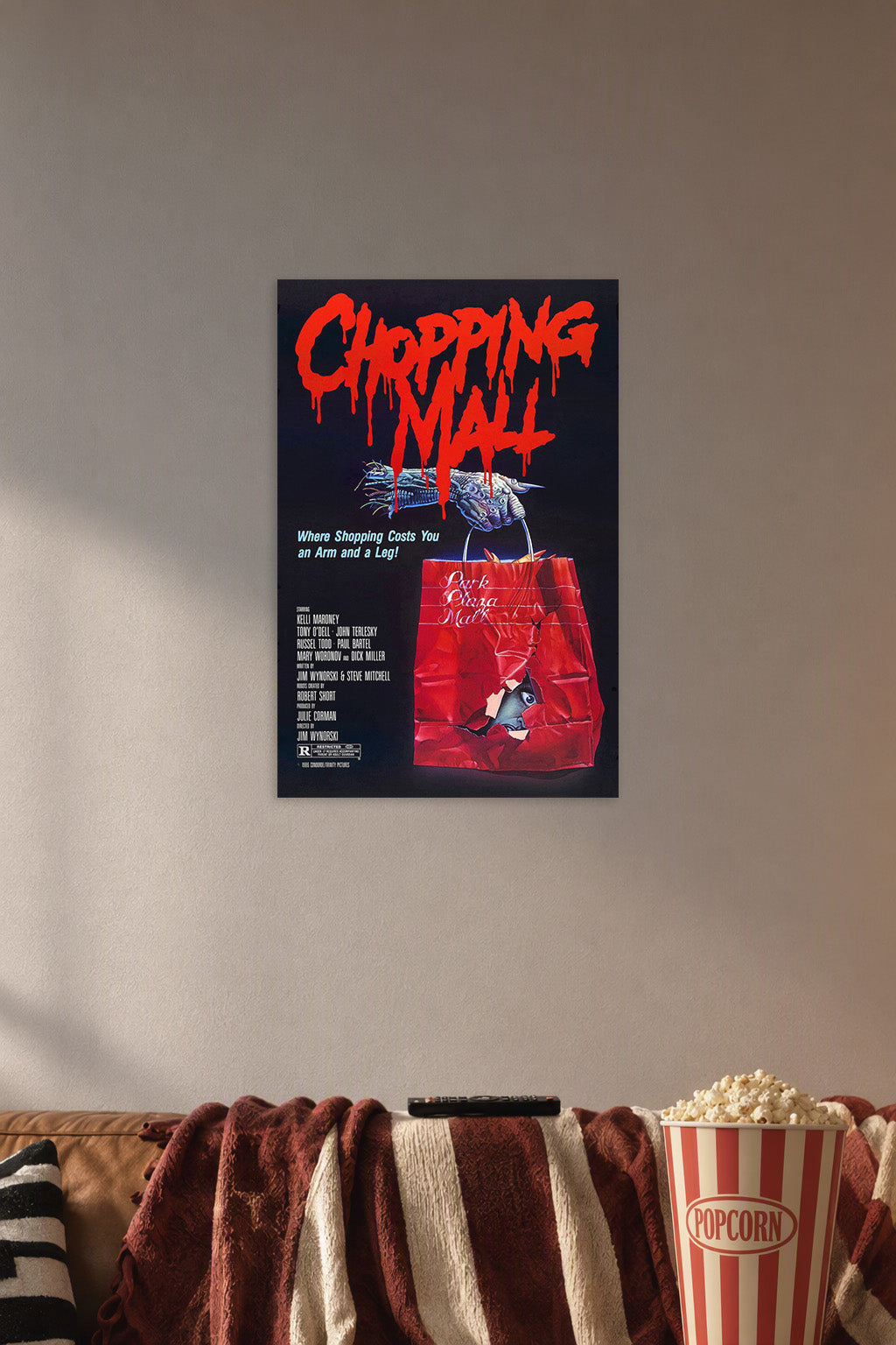 Chopping Mall Horror Movie Poster in a cozy movie room above a brown sofa with popcorn.