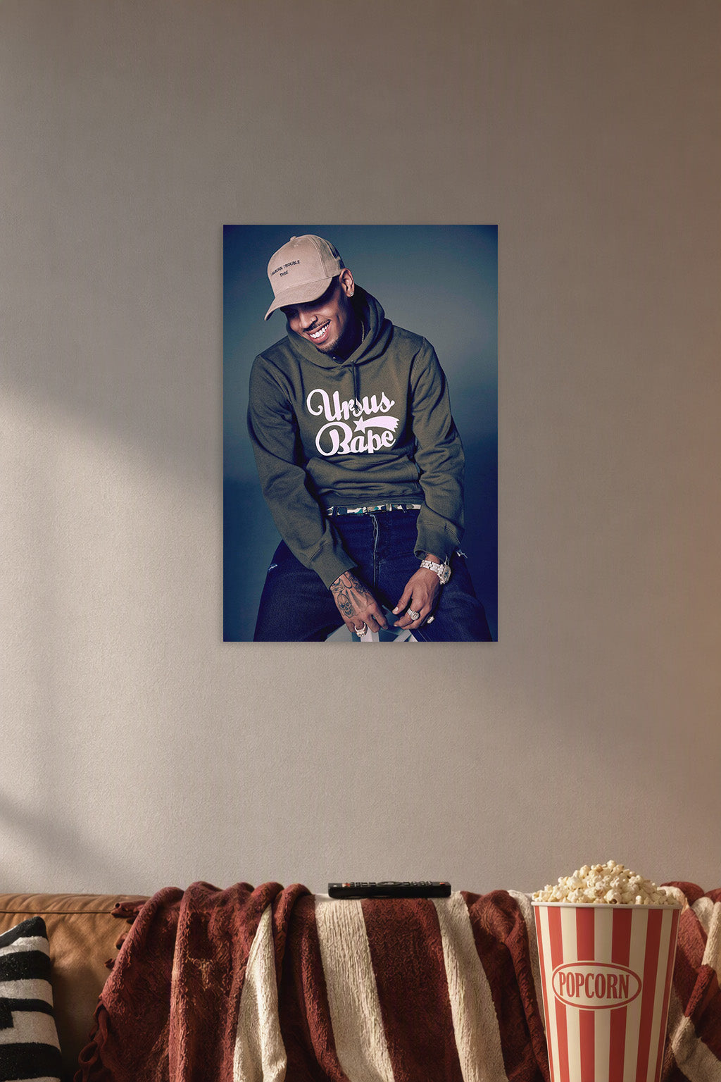 Chris Brown in a cozy movie room above a brown sofa with popcorn.