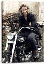 Chris Hemsworth canvas wall art print displays the smiling actor on a black motorcycle, with wrapped edges visible against white.