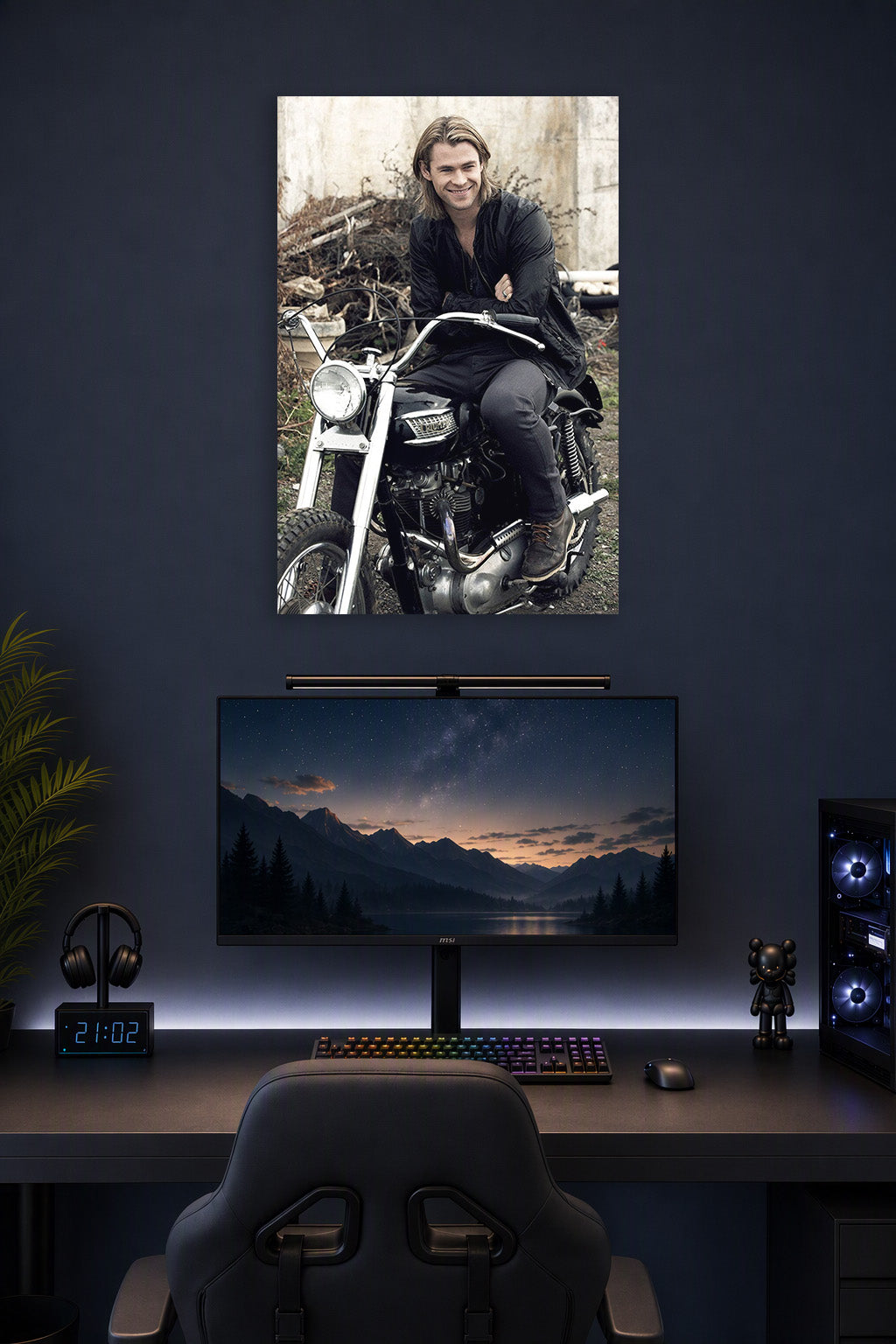 Chris Hemsworth in a gaming desk setup above a monitor.