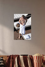 Chris Hemsworth in a cozy movie room above a brown sofa with popcorn.