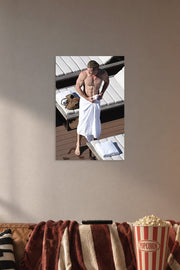 Chris Hemsworth in a cozy movie room above a brown sofa with popcorn.
