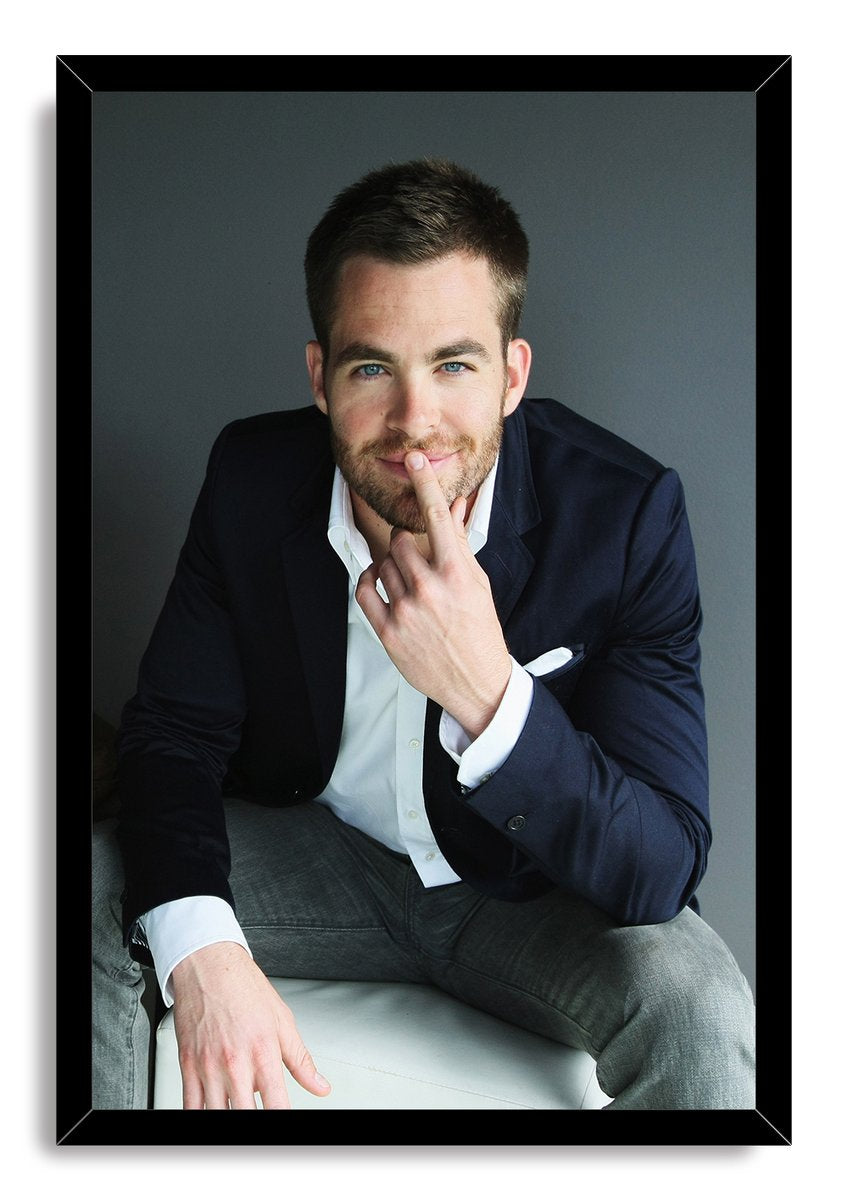 Chris Pine framed wall art print displays a seated portrait with a navy jacket, white shirt, gray trousers, and black border.