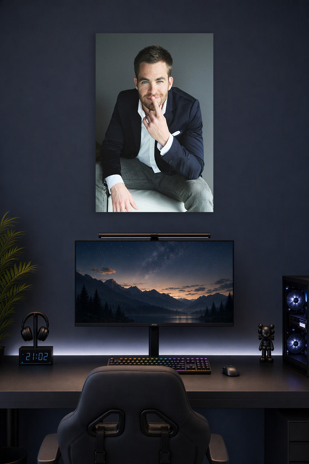 Chris Pine in a gaming desk setup above a monitor.