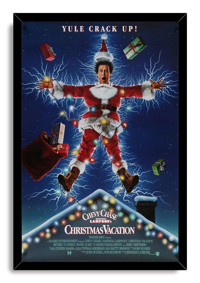 Christmas Vacation framed wall art print depicts Clark Griswold in a Santa costume amid lightning, presents, holiday lights, and a snow-covered roof.