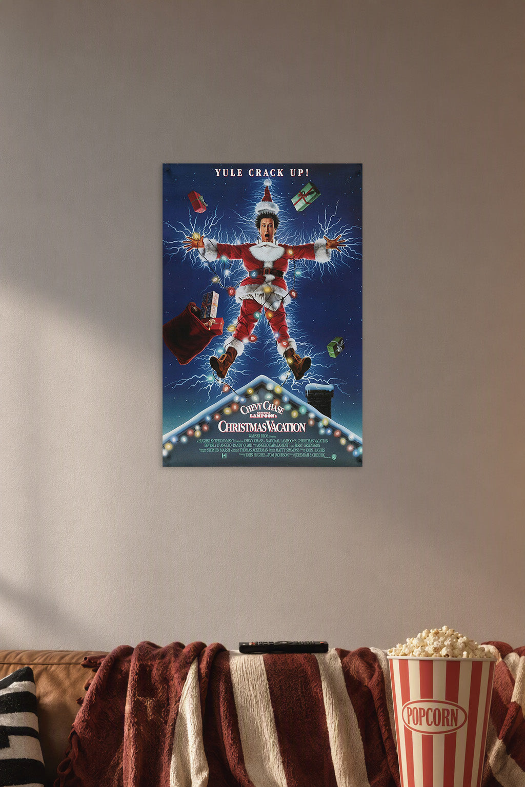 Clark Griswold Christmas Vacation in a cozy movie room above a brown sofa with popcorn.