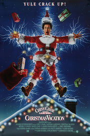 Christmas Vacation poster features Clark Griswold in a red Santa suit, tangled in glowing lights and lightning above a snowy roof.