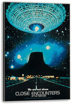 Close Encounters of the Third Kind wall art print on a stretched canvas, with a luminous UFO over Devil's Tower and starry blue sky.