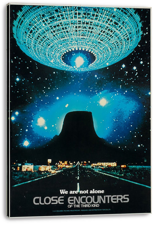 Close Encounters of the Third Kind wall art print on a stretched canvas, with a luminous UFO over Devil's Tower and starry blue sky.