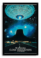 Close Encounters of the Third Kind framed wall art print depicts a turquoise spacecraft, dark Devil's Tower, and illuminated road beneath stars.