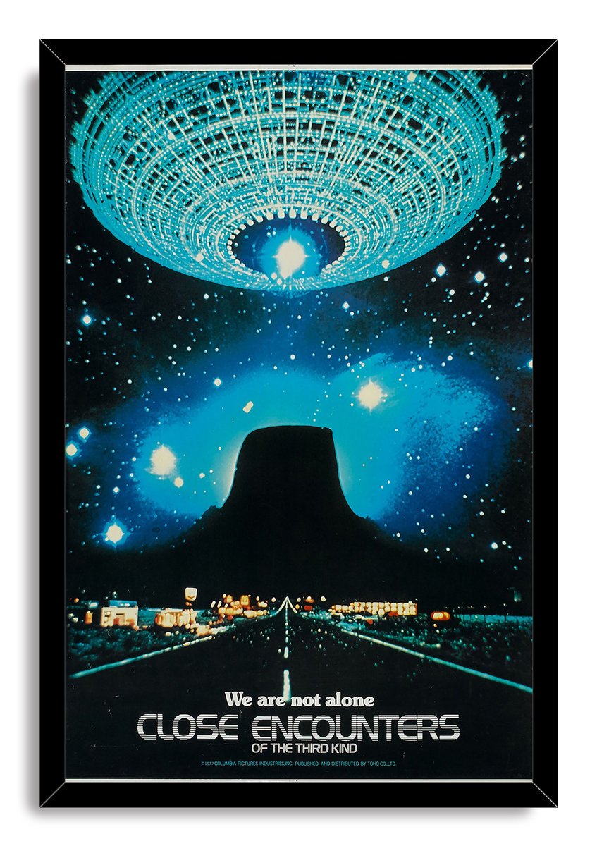 Close Encounters of the Third Kind framed wall art print depicts a turquoise spacecraft, dark Devil's Tower, and illuminated road beneath stars.