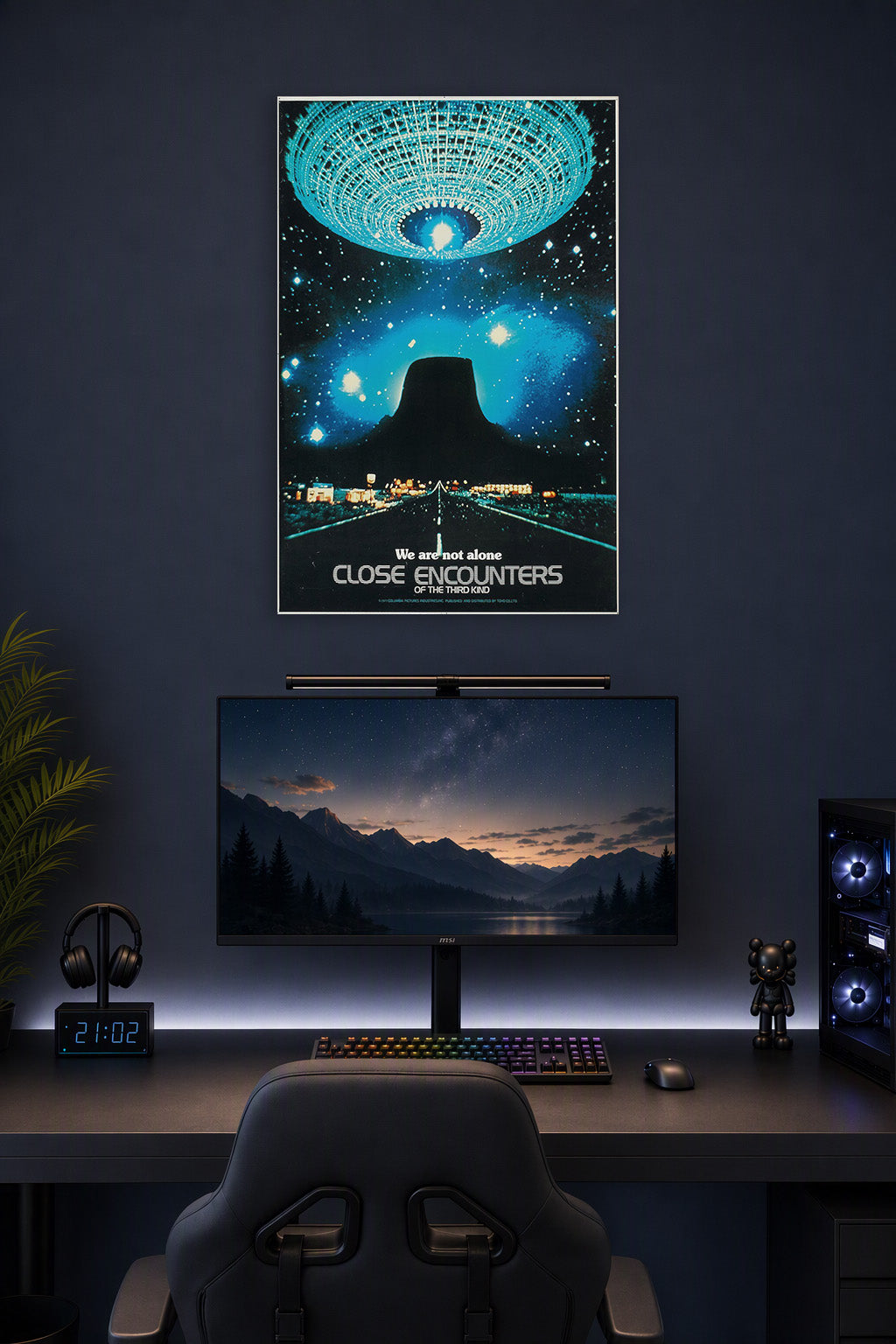 Close Encounters of the Third Kind in a gaming desk setup above a monitor.