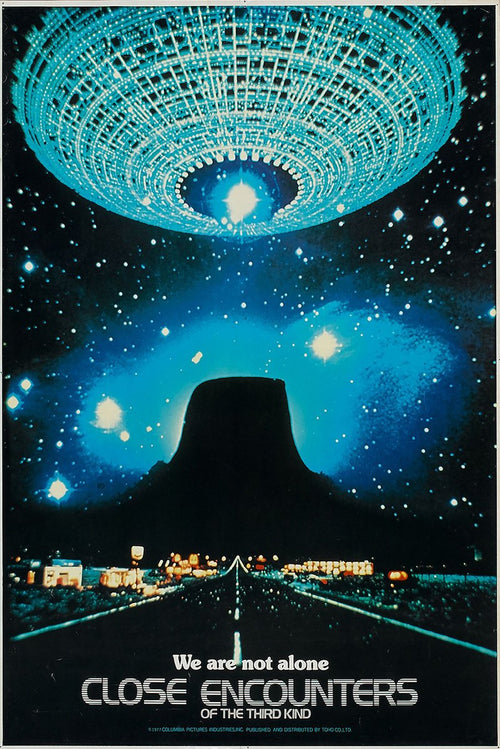 Close Encounters of the Third Kind poster features a glowing turquoise mothership above Devil's Tower and a lit highway at night.