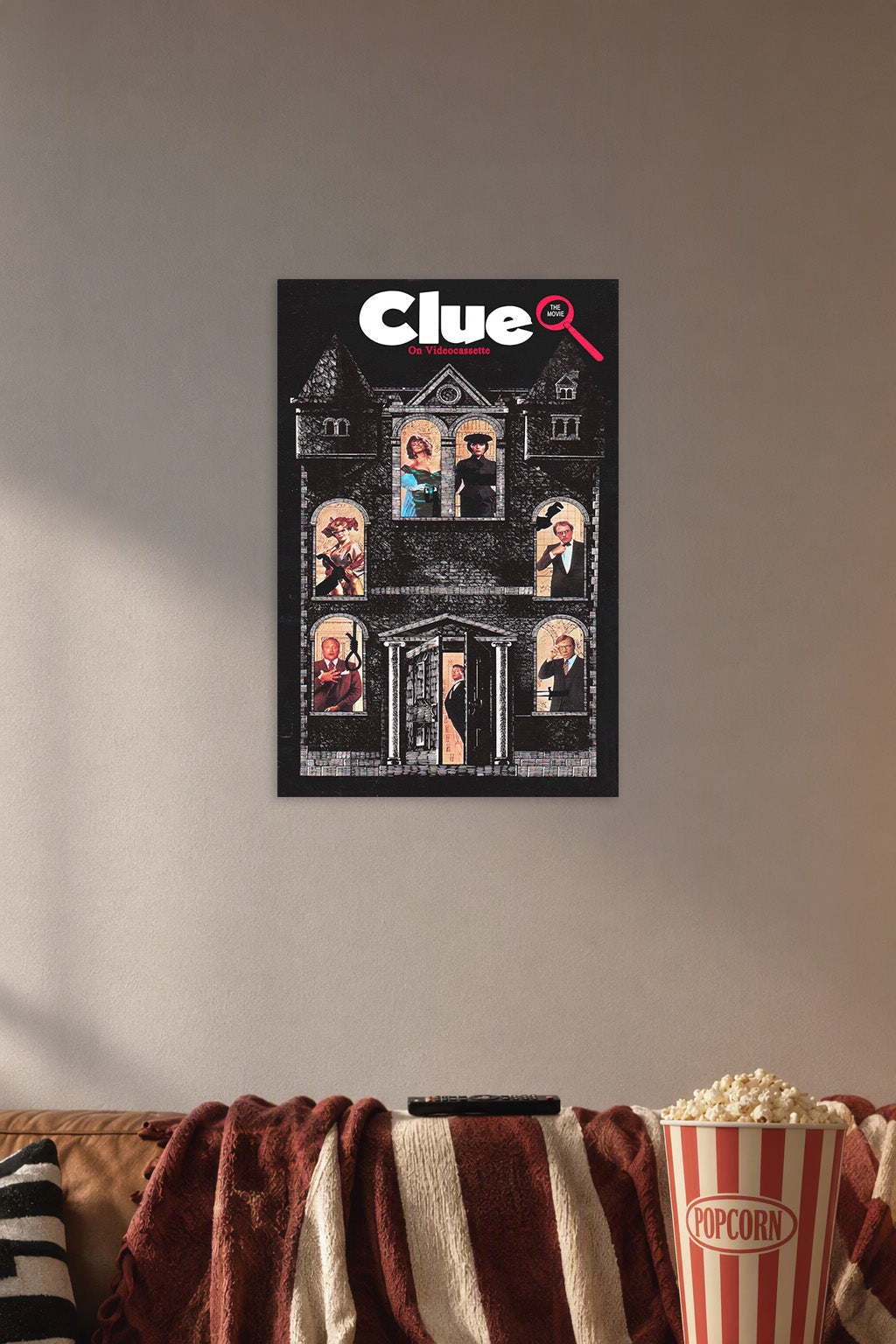 Clue Movie in a cozy movie room above a brown sofa with popcorn.