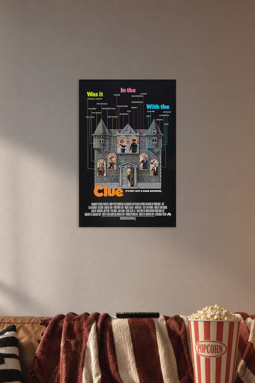 Clue Movies in a cozy movie room above a brown sofa with popcorn.