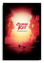 Cobra Kai framed wall art print in a black frame, featuring rival faces, logo text, and beach karate silhouettes at sunset.