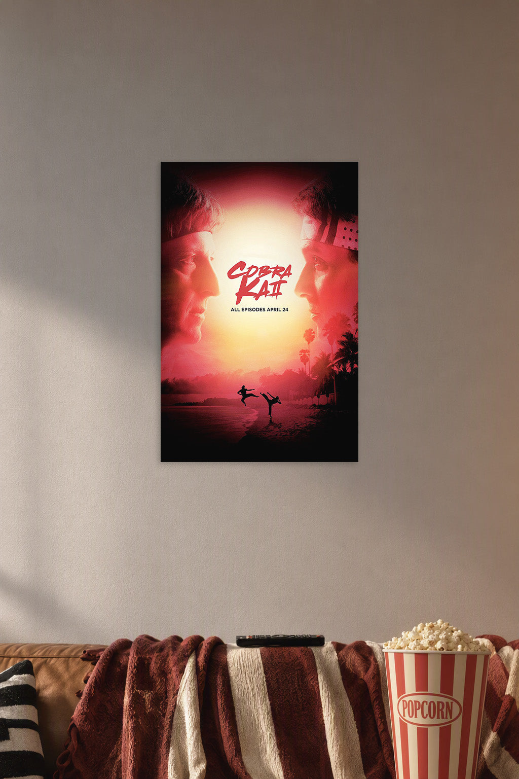 Cobra Kai in a cozy movie room above a brown sofa with popcorn.