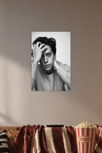 Cole Sprouse in a cozy movie room above a brown sofa with popcorn.