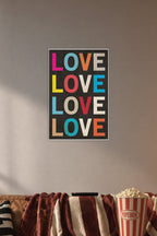 Colorful LOVE Text in a cozy movie room above a brown sofa with popcorn.