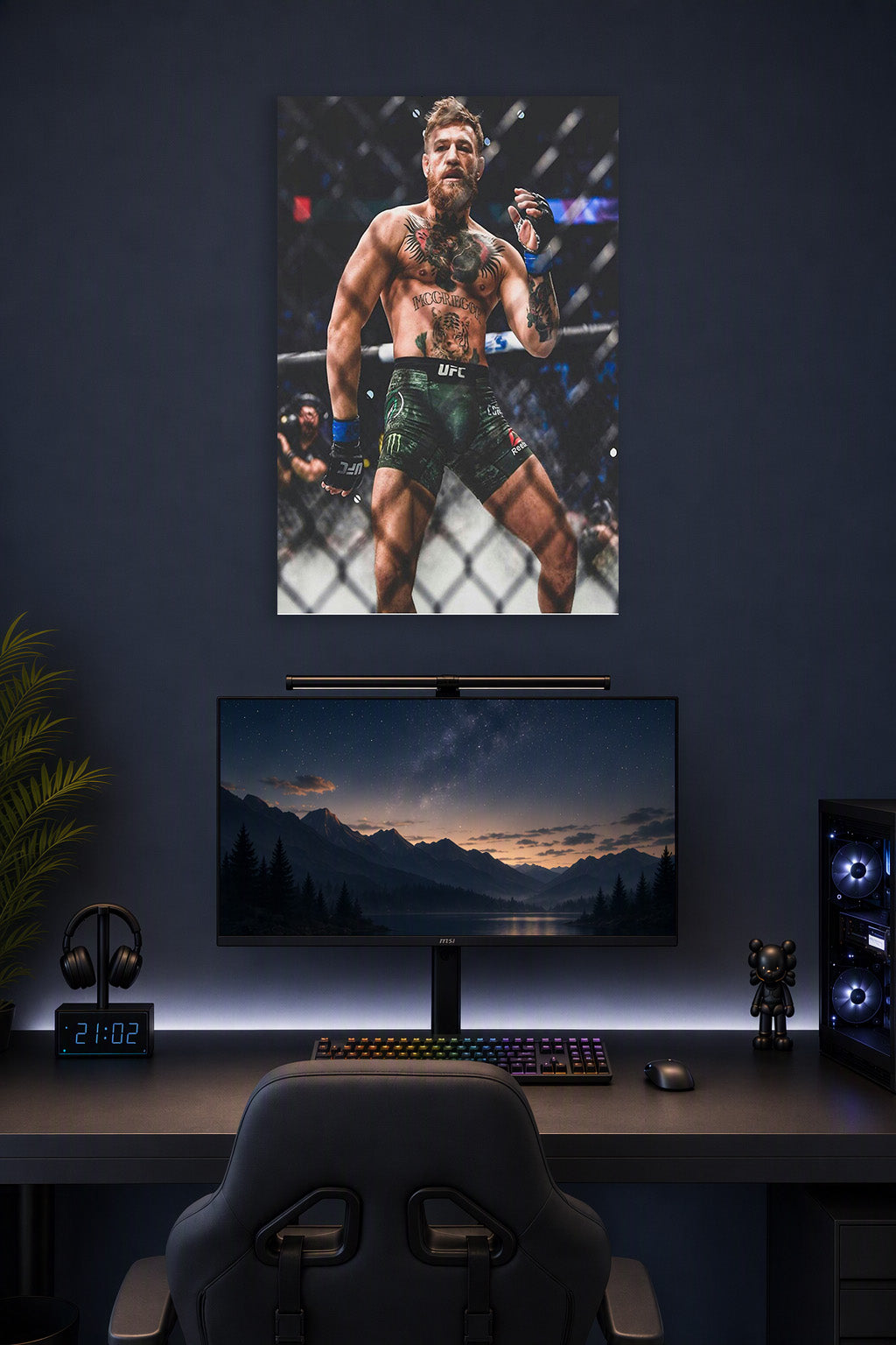 Conor McGregor in a gaming desk setup above a monitor.