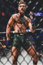 Conor McGregor poster features the tattooed MMA fighter in black and green UFC shorts inside a dimly lit octagon.