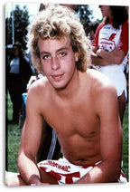 Corey Haim canvas wall art print displays the curly blond actor seated outdoors, with a red-and-white garment at his waist.
