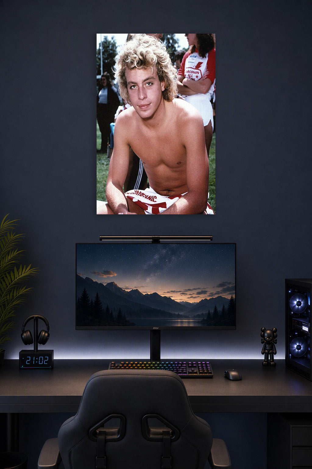 Corey Haim in a gaming desk setup above a monitor.