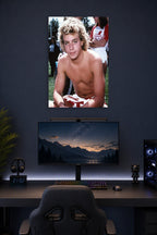 Corey Haim in a gaming desk setup above a monitor.