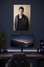 Cory Monteith in a gaming desk setup above a monitor.