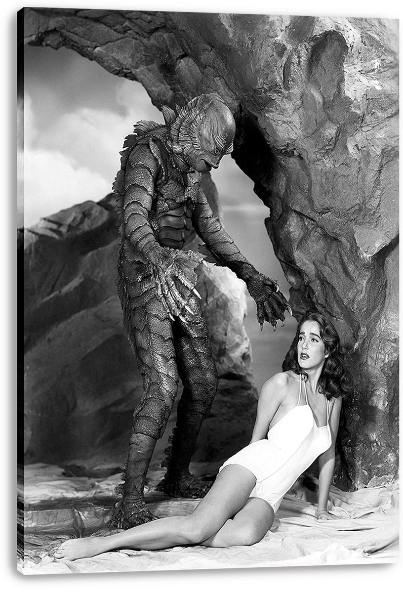 Creature From the Black Lagoon canvas wall art print presents the Gill-man and a seated woman in a black-and-white rocky shoreline scene.