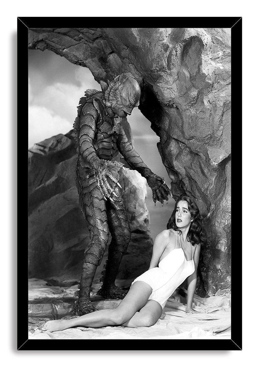 Creature From the Black Lagoon framed wall art print features the Gill-man looming over a woman in white beneath a dramatic stone arch.