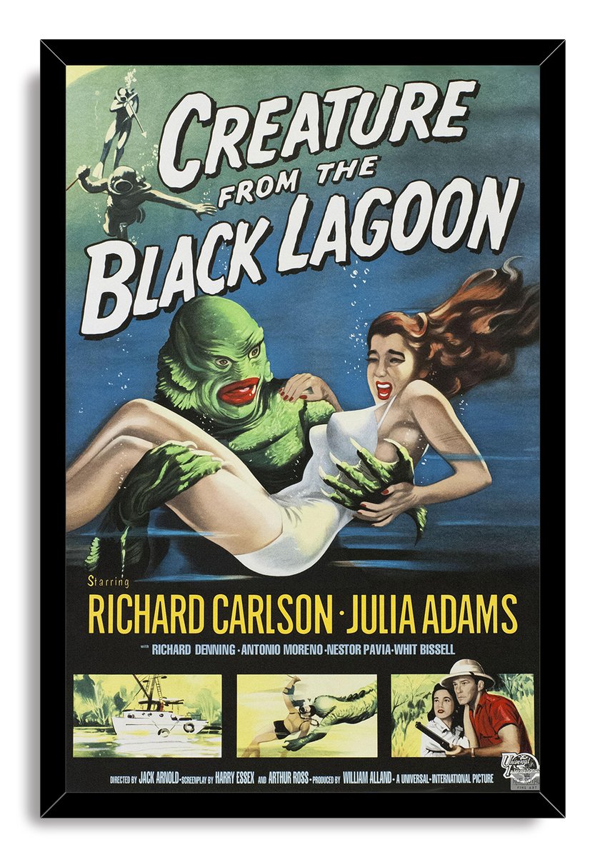 Creature from the Black Lagoon framed wall art print depicting the Gill-man holding a woman underwater, with a black border and vintage credits.
