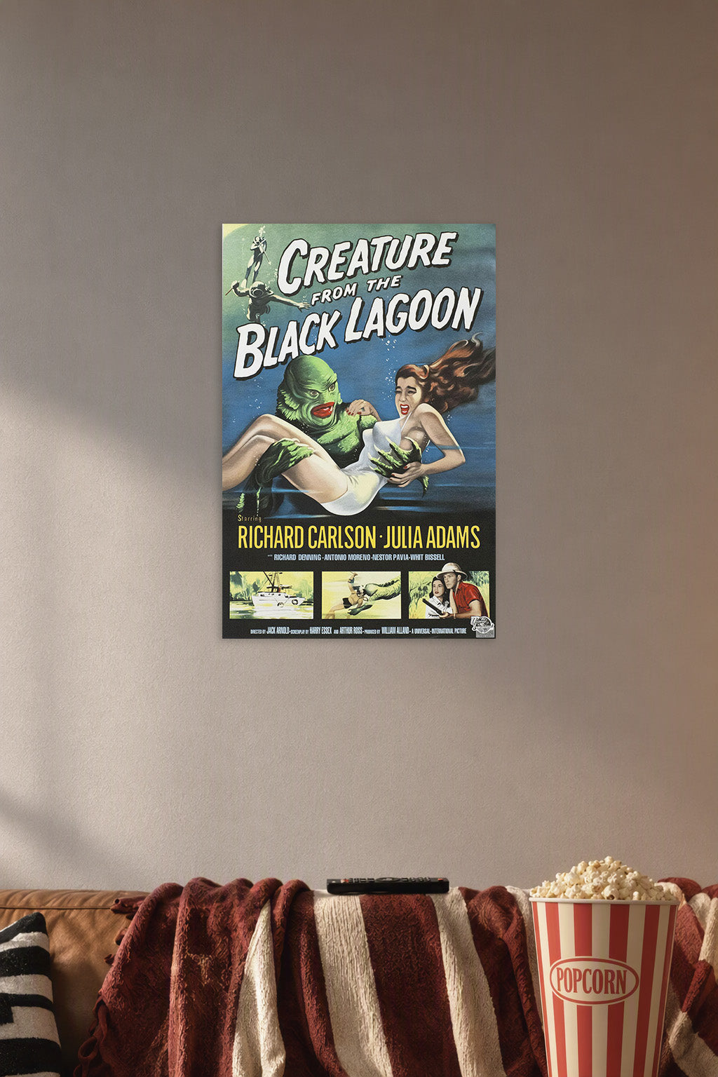 Creature from the Black Lagoon in a cozy movie room above a brown sofa with popcorn.