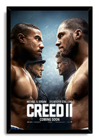 Creed II framed wall art print with a black border, featuring opposing boxers, their mentors, and large white film title lettering.