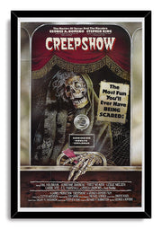 Creepshow framed wall art print in a black frame depicts the grinning hooded Creep, ticket booth, red curtains, and horror-film typography.
