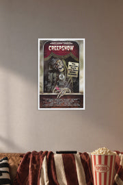 Creepshow Movie Poster in a cozy movie room above a brown sofa with popcorn.