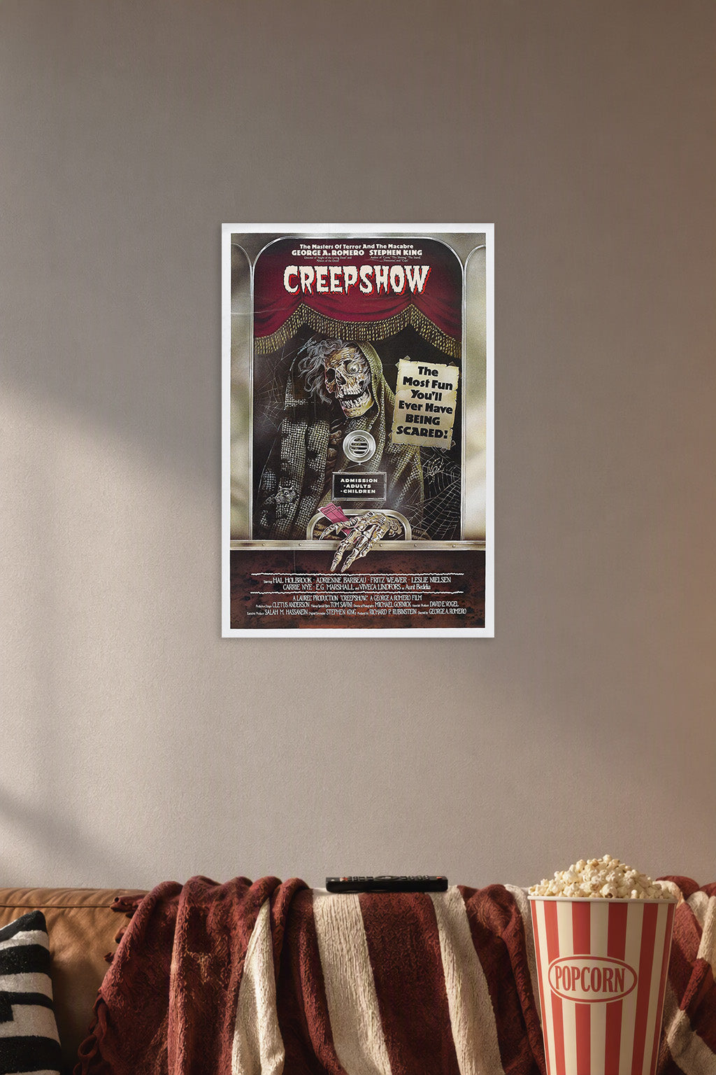 Creepshow Movie Poster in a cozy movie room above a brown sofa with popcorn.