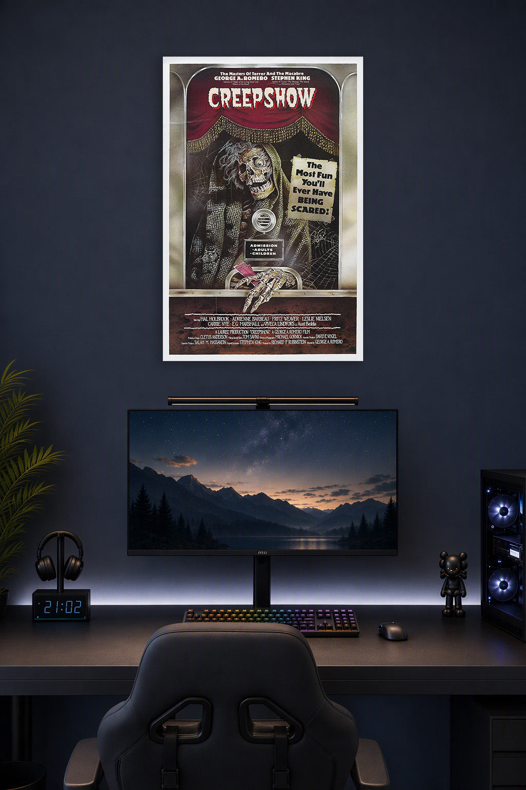 Creepshow Movie Poster in a gaming desk setup above a monitor.