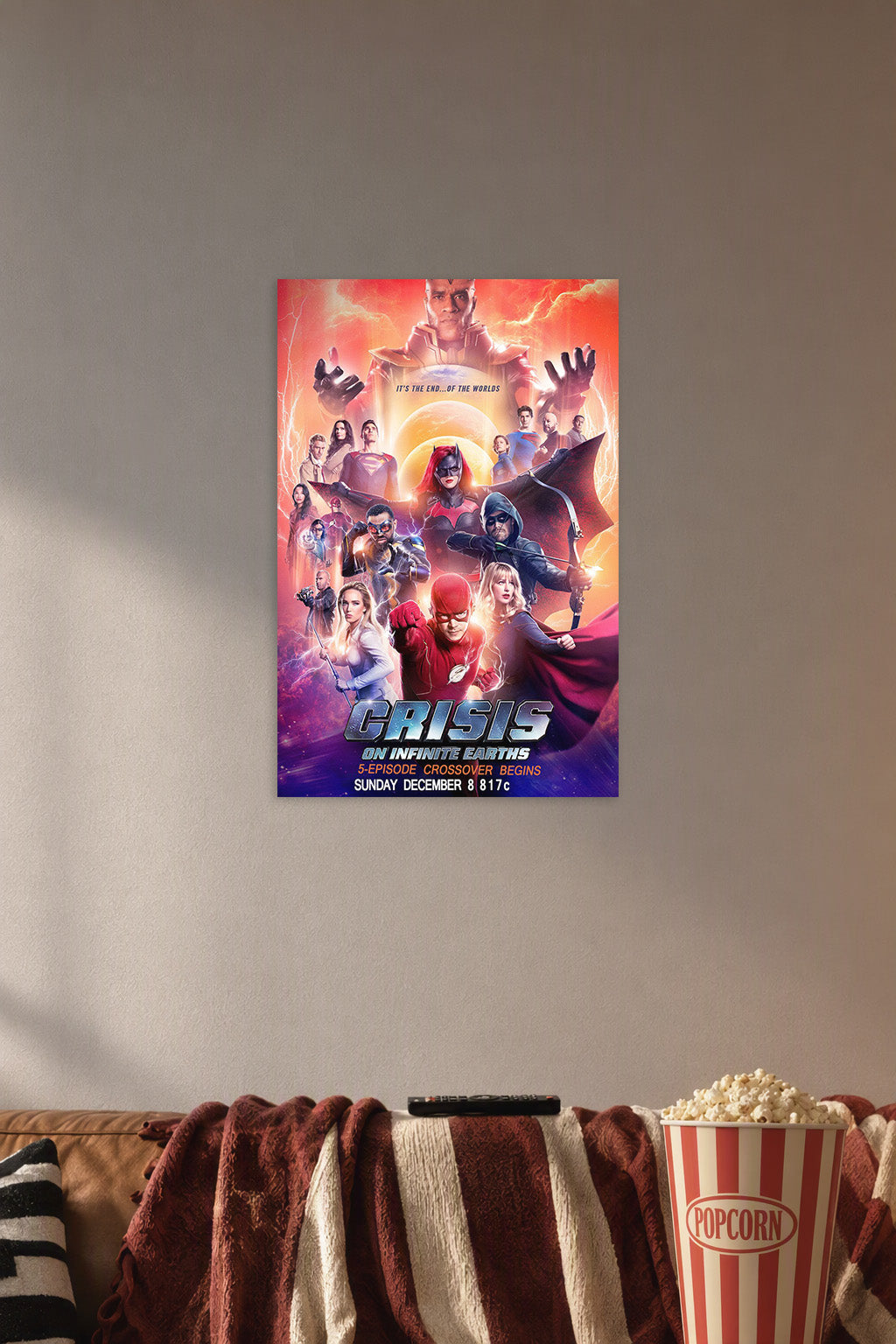 Crisis on Infinite Earths in a cozy movie room above a brown sofa with popcorn.