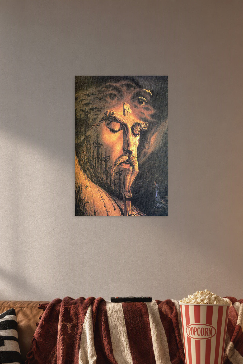 Crucifixion of Jesus in a cozy movie room above a brown sofa with popcorn.